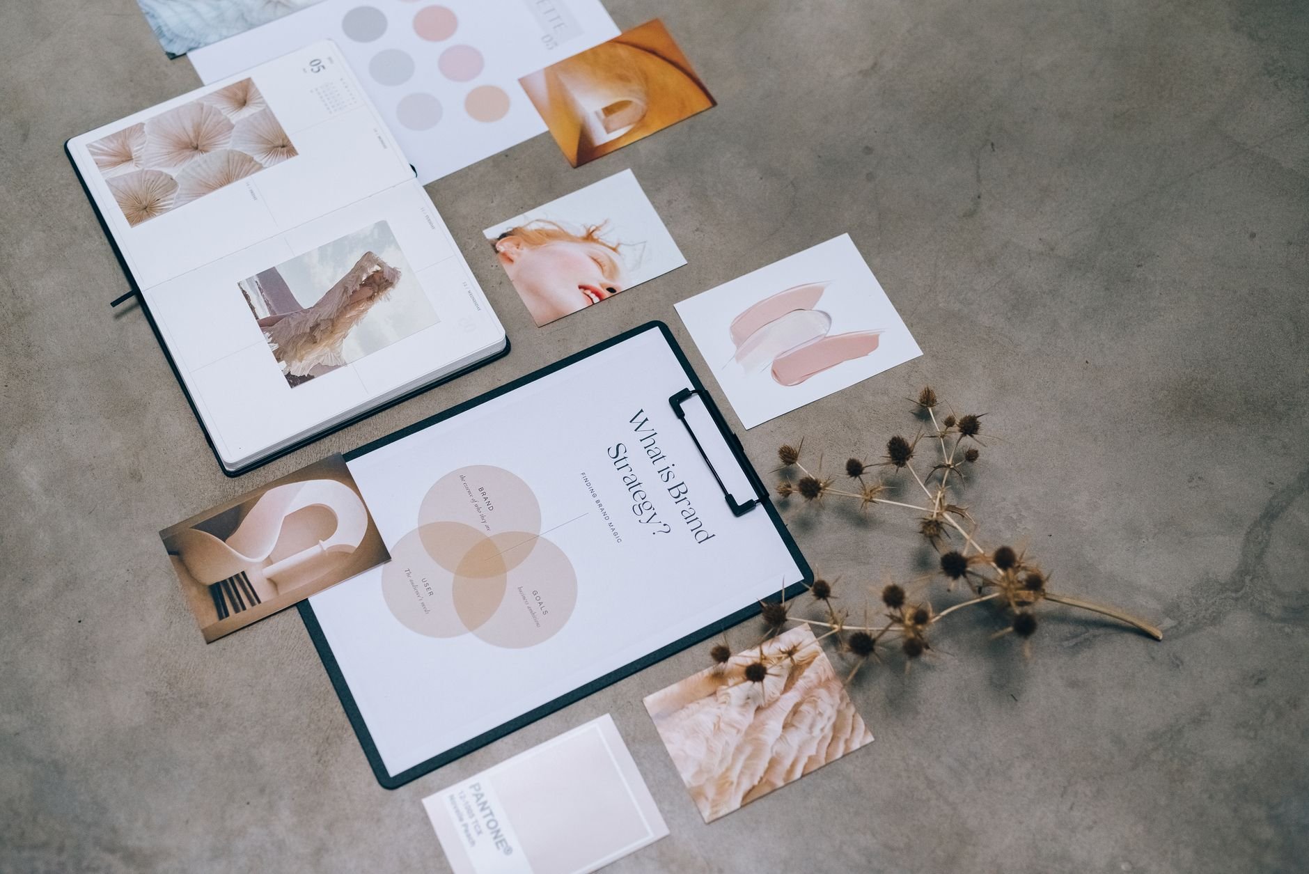 A modern flat lay of branding strategy documents and design elements on a desk.